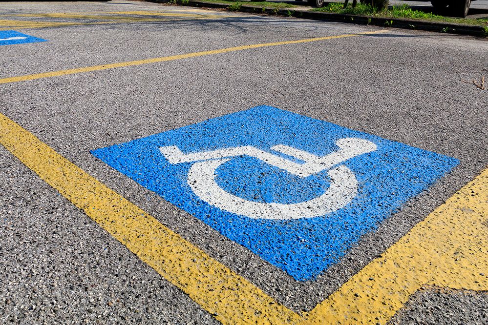 Caption: A photo of a wheelchair-accessible parking spot marked in paint on the ground. (Getty Images)