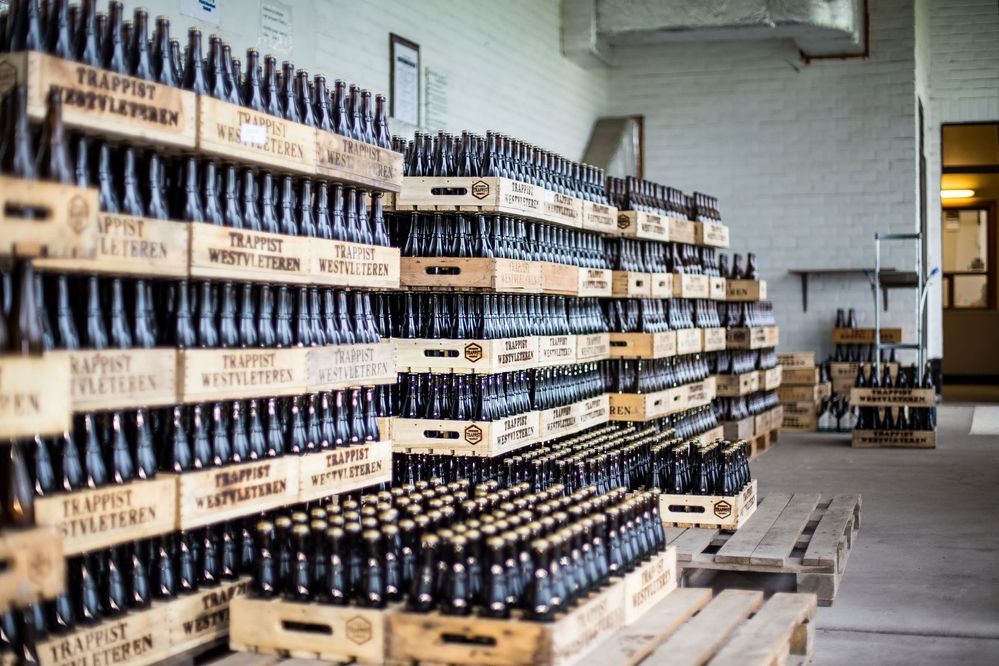 Caption: A photo of cases of beer bottles stacked up against a wall at Westvleteren Brewery. (Local Guide Casper van Dort)