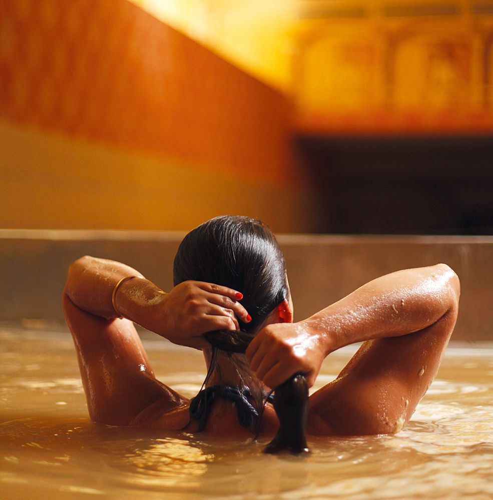 Caption: A photo of a woman in a beer pool at Starkenberger in Austria. (Courtesy of Starkenberger)