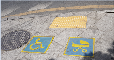 Caption: A photo of a wheelchair-accessible plus children stroller spot in the roadside pathway