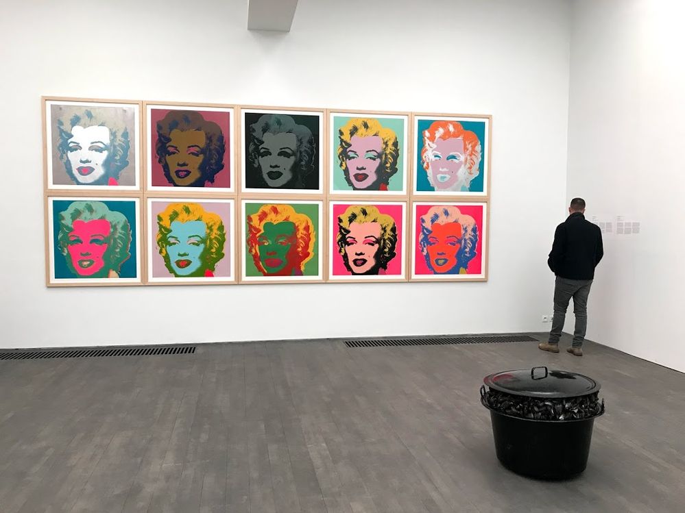 Caption: A photo of Andy Warhol’s “Marilyn Monroe,” a series of ten prints featuring the same headshot of Marilyn Monroe each rendered in different colors, hanging in Belgium’s Municipal Museum of Contemporary Art. (Local Guide Colin Tonge)