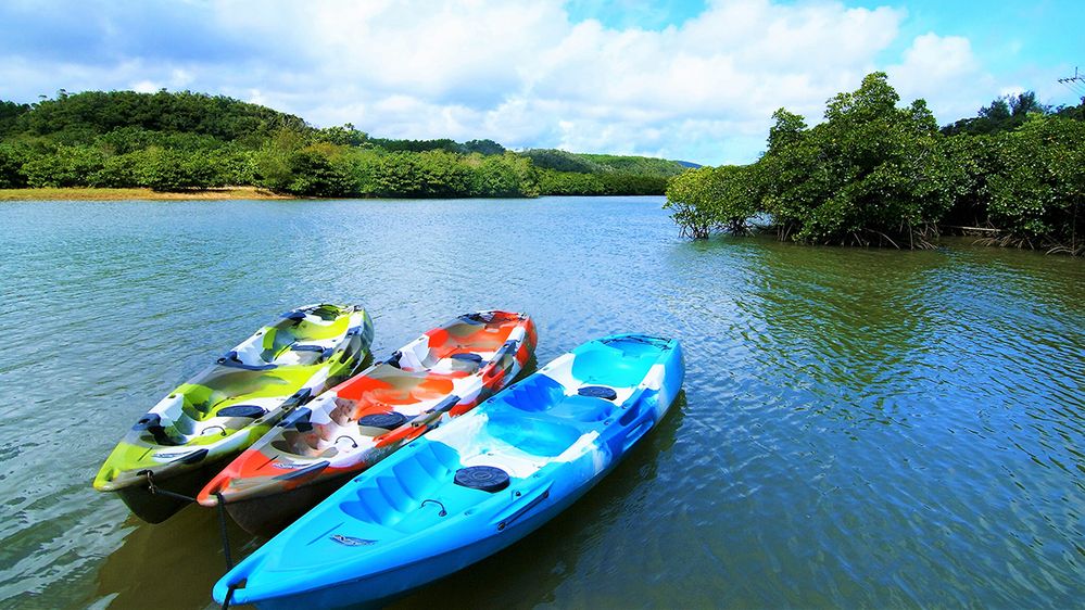 Caption: A photo of empty kayaks resting on a river in Nago, Okinawa, Japan. (Local Guide Fumitaka Toma)