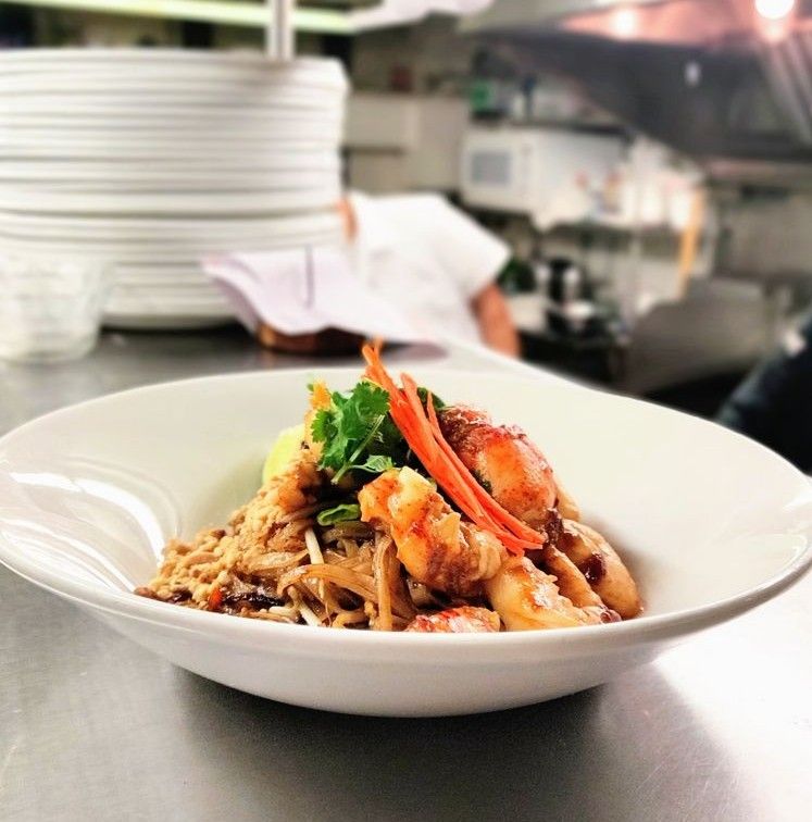 Caption: A photo of a bowl of shrimp pad thai. (Local Guide @adi_pix)