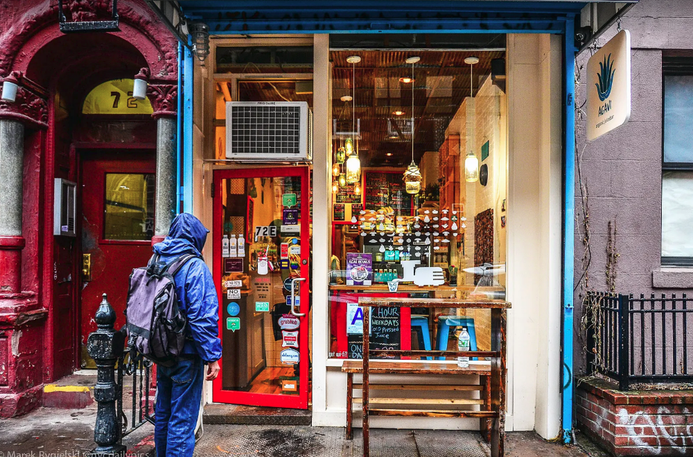Caption: A photo of a person dressed in rain gear looking at a storefront. (Local Guide Marek Rygielski)