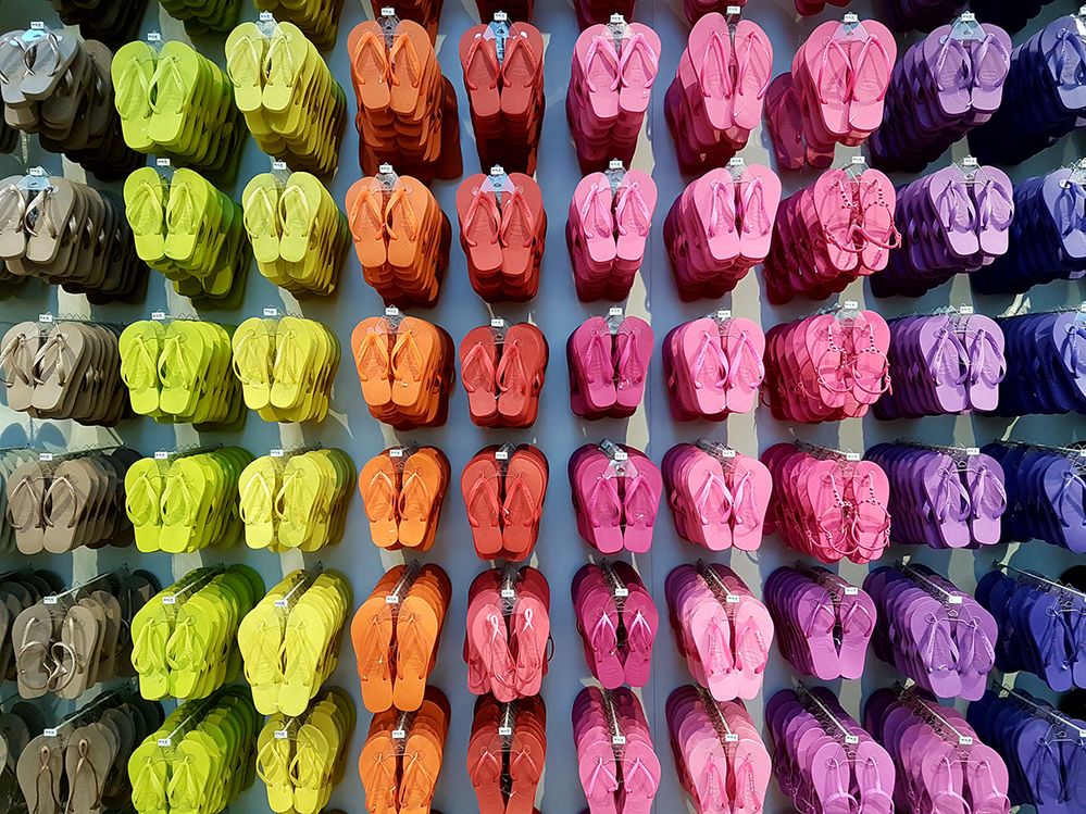 Caption: A photo of a variety of flip flops in different colors hanging on a wall display in a Havaianas store in São Paulo, Brazil. (Local Guide Gabriel Borges)