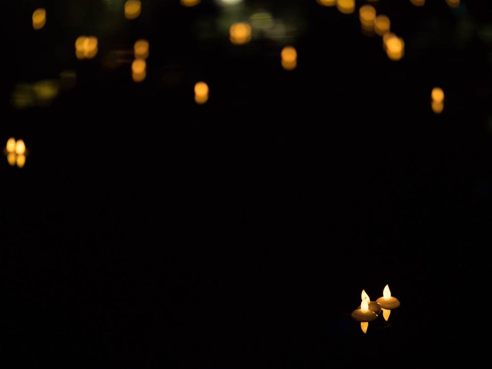 out of focus floating candles behind the three in the foreground are bokeh