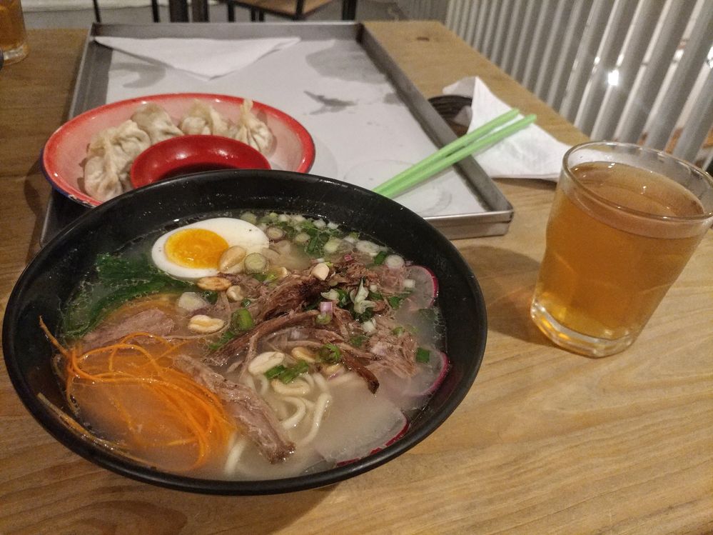 Caption: the best ramen I have had so far, it came with free tea too. I also had some dumplings.