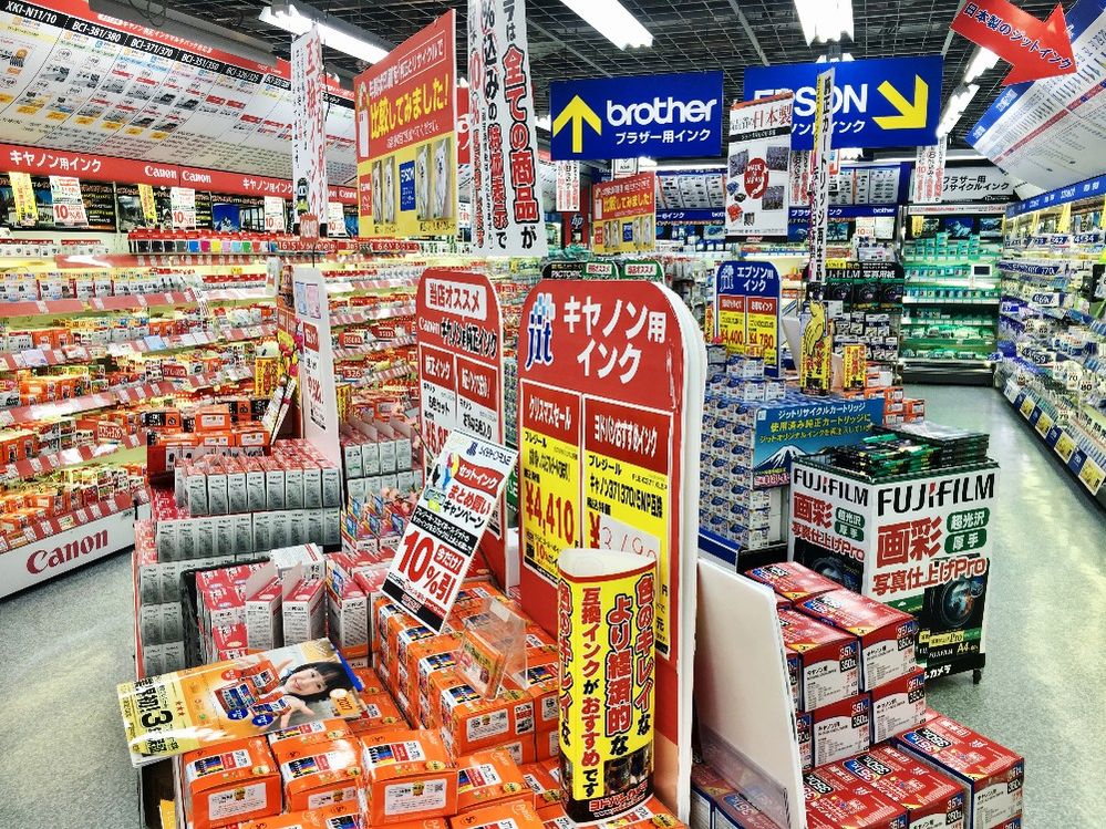 Caption: A photo of the interior of Yodobashi Camera Shinjuku West Main Store in Tokyo, Japan that shows shelves filled with cameras and camera equipment. (Local Guide VENOX 360)