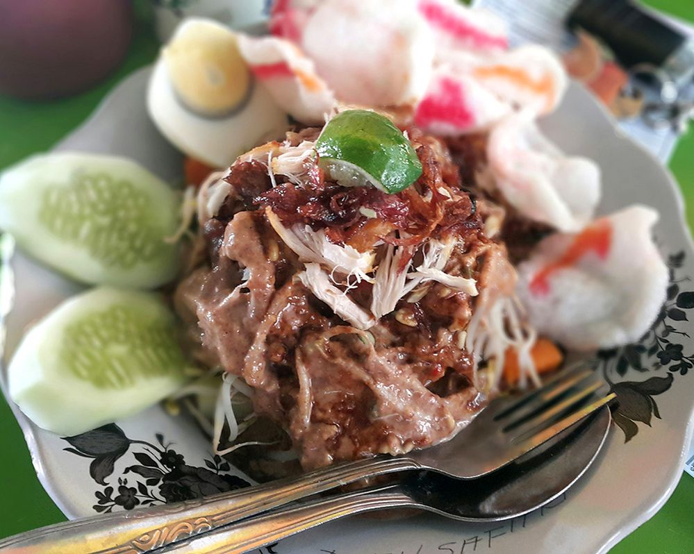 Caption: A photo of a popular Indonesian-style salad called “gado-gado” on a plate with a fork and spoon. (Getty Images)
