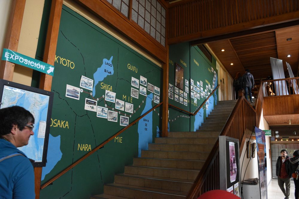 Caption: A photo of the stairs, on the wall there's a map of Japan and some photos that show it's history. Farid is also in the left of the photo :)