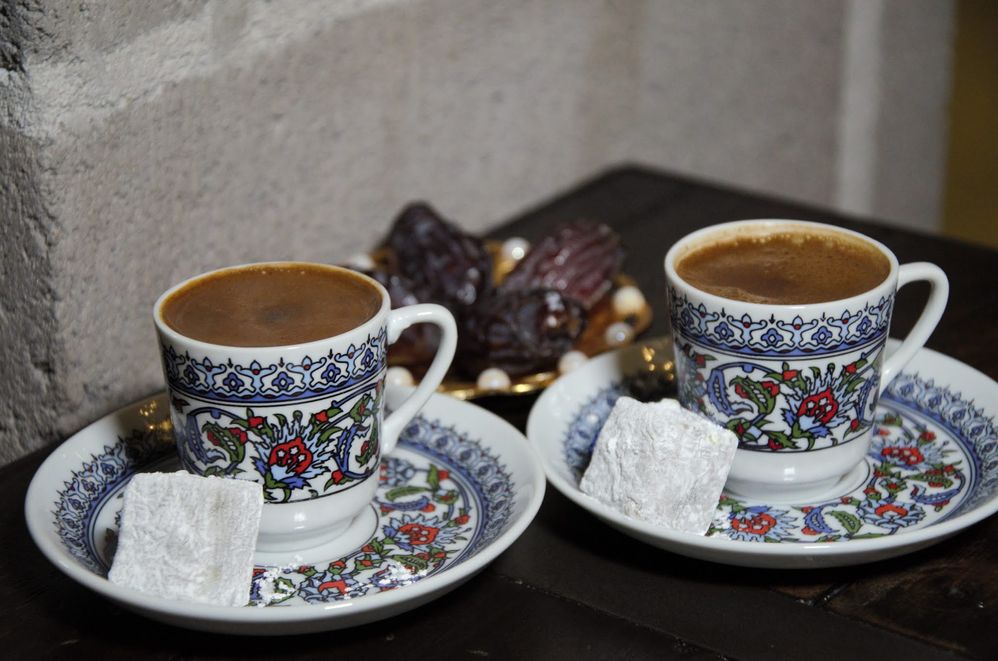 Caption: A photo of two coffees in decorative cups on matching saucers next to a large sugar cube at Anatolia in Campsie, New South Wales, Australia. (Local Guide Alexandra Lalaneats)