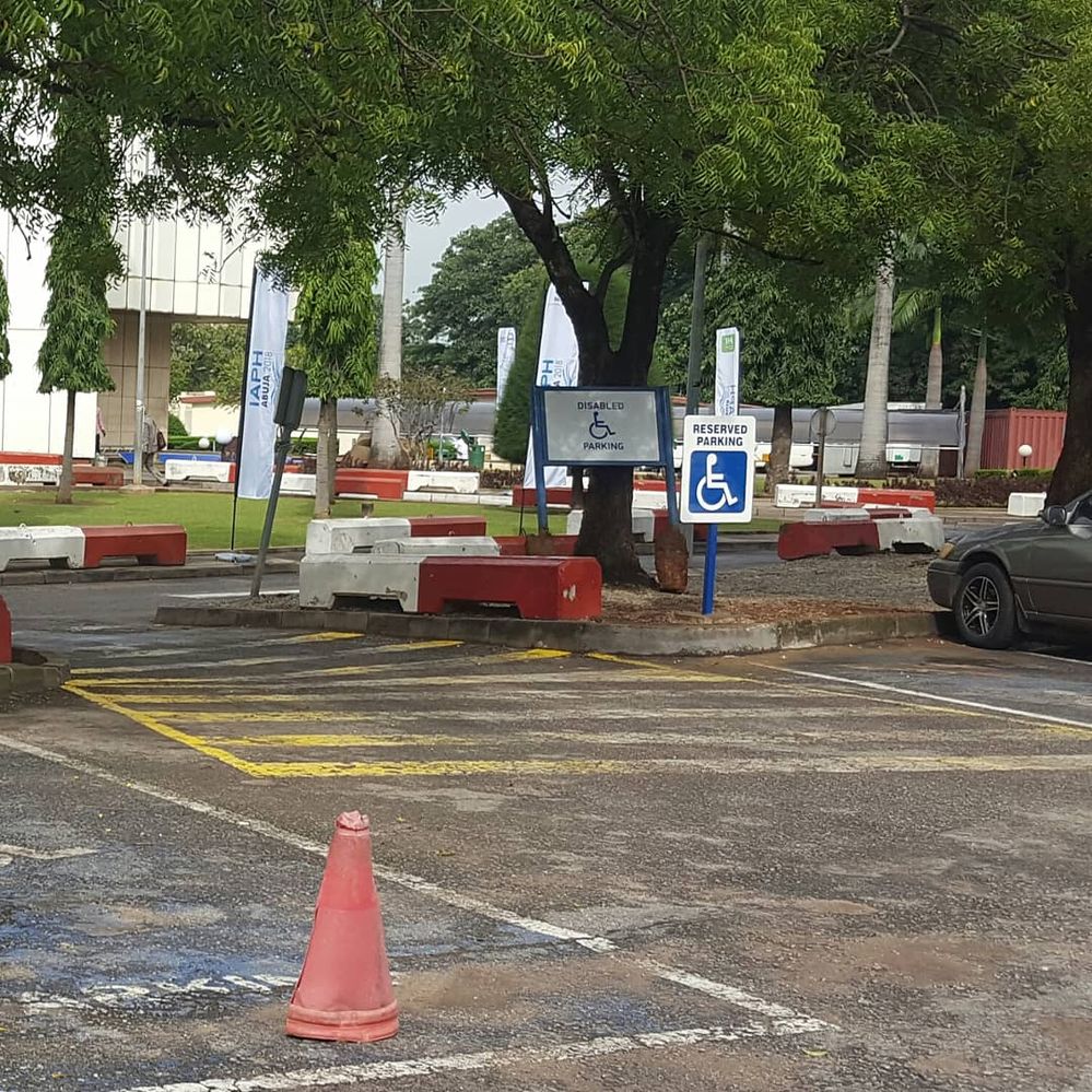 Caption: Wheelchair parking and reserved area with signs at Transcorp Hilton, Abuja