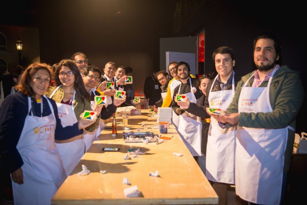 Caption: A photo of Local Guides holding up their freshly decorated Google Maps cookies at Connect Live Lima 2018.