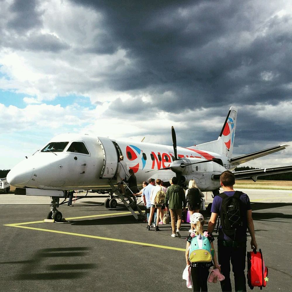 Caption: A photo of a line of people boarding a propellor plane on the tarmac at Finland’s Kokkola-Pietarsaari Airport. (Local Guide ruddy karundeng)