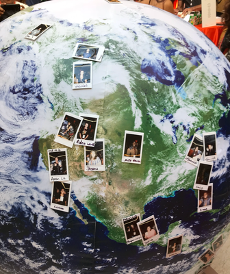 instax photos on a globe