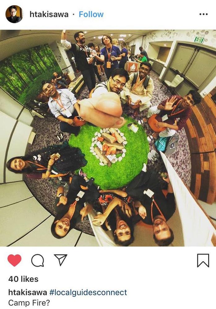 Caption: An Instagram post of a 360 degree photo of Local Guides around a decorative campfire. (@htakisawa)