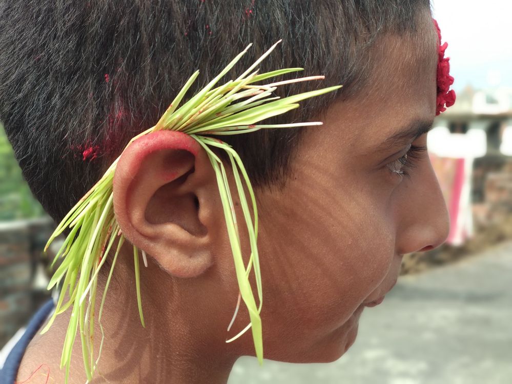 Boy with "Jamara"  in his ear and " Tika " in his forehead.