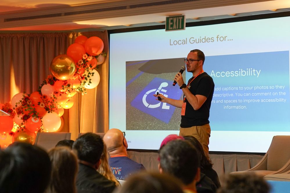Caption: A photo of Local Guides Program Manager @JuanCh speaking during Connect Live 2018.