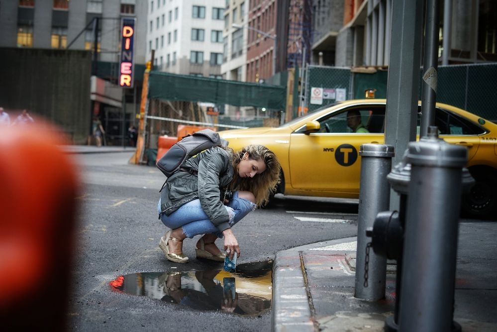 Caption: A photo of me in my natural habitat, taking photos over a puddle in New York City.