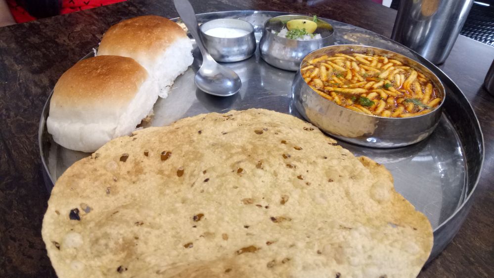 "Misal Pau"  the gravy making by Mung Beans served with Buns ,Curd and Onion Salad with Crunchy Papadam very Famous in West India