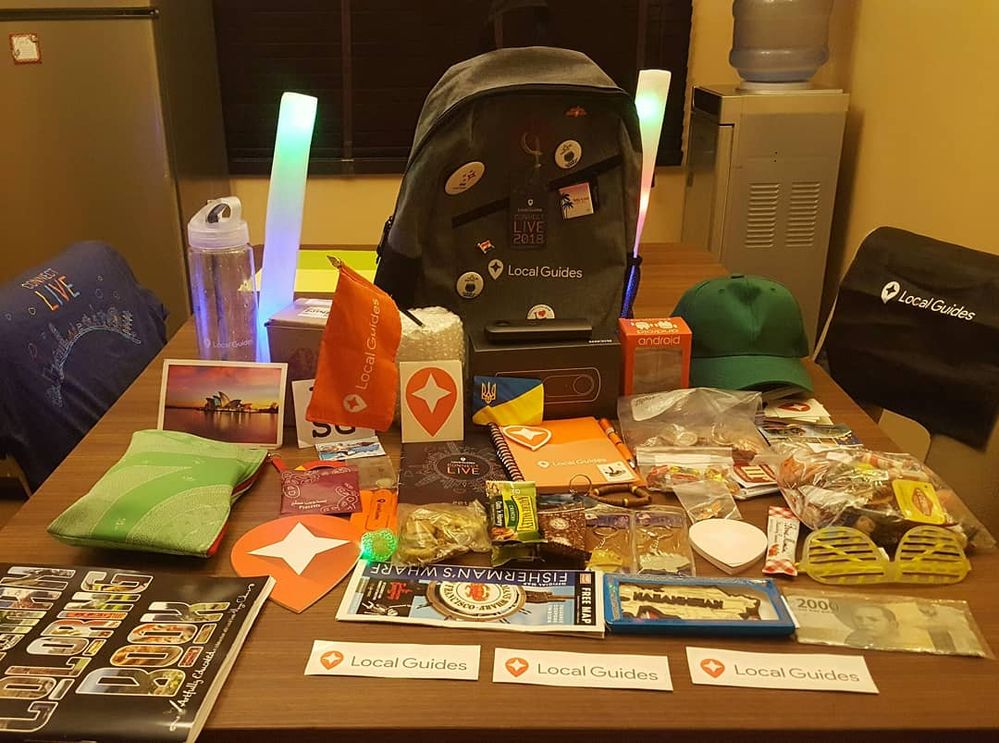 A collection of numerous gift items from Connect Live 2018 places on a table