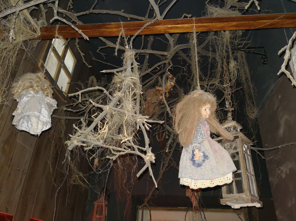Caption: A creepy photo of dolls hung from a wooden beam along with sticks and other spooky decorations at Lost Souls Alley in Krakow, Poland. (Local Guide Kamil Ły)