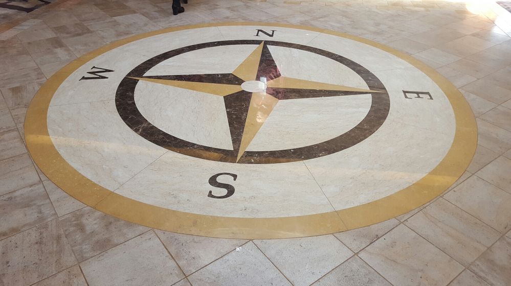 Caption: A compass as seen on the floor of the North Point Lounge venue of the Connect Live welcome reception