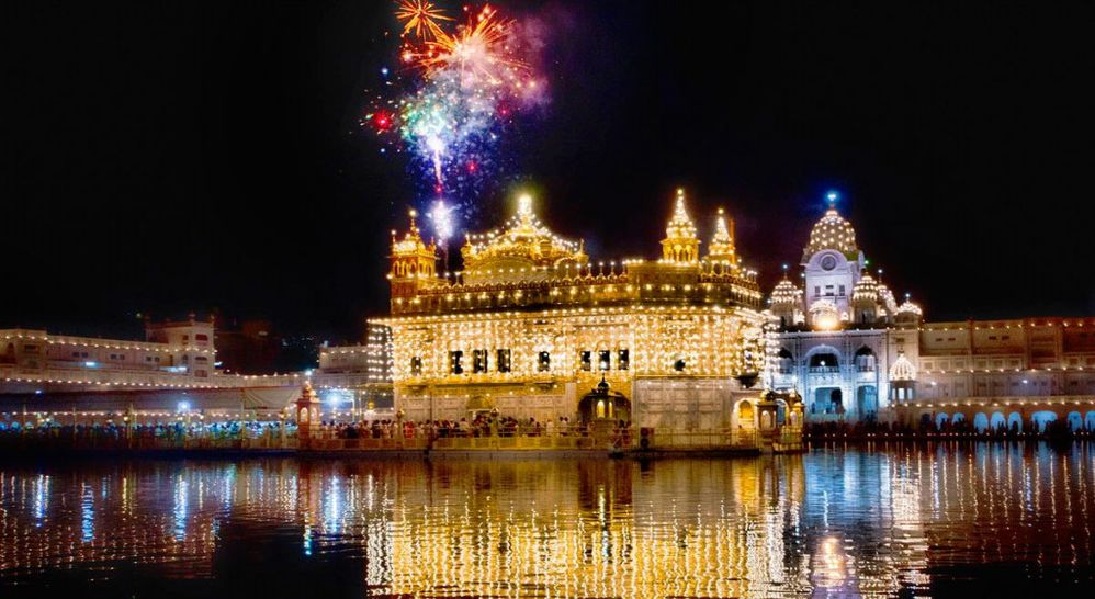 Caption: A night-time shot of the Golden Temple in Amritsar, India, lit up with fireworks overhead. (Local Guide Manish Sharma)