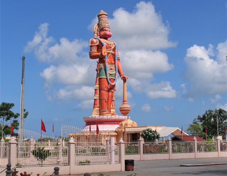 Caption: A photo of a gigantic statue of the monkey god, Lord Hanuman, standing outside the Dattatreya Temple Compound in Trinidad and Tobago. (Local Guide Philip Siong)