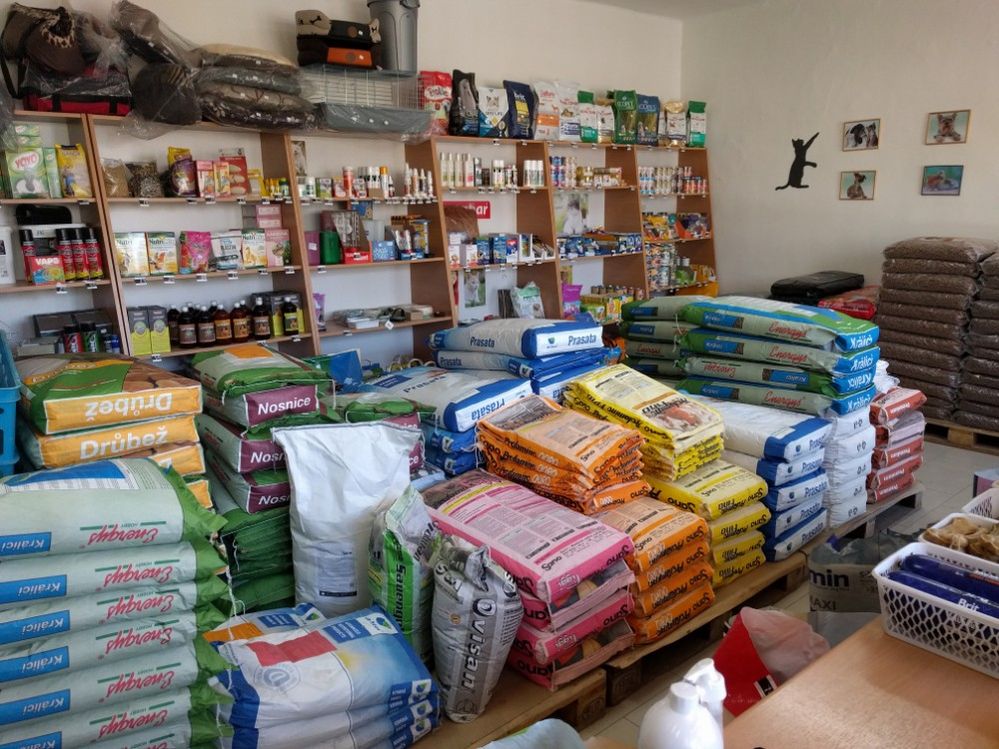 Caption: A photo of large pet food bags stacked in front of shelves full of pet products at a pet store in Bodrogom, Slovakia. (Local Guide David Danko)