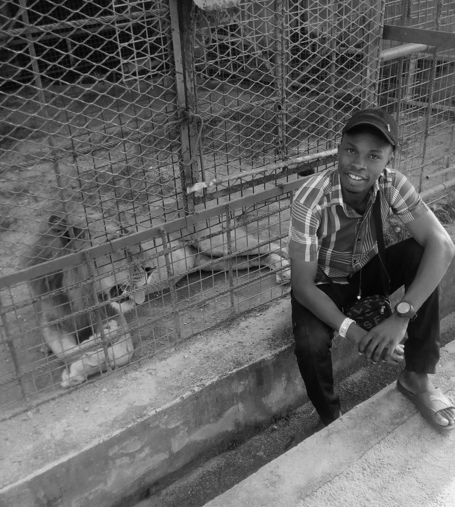 A monochrome picture of myself and "the king of the Jungle but in a steel cage " on one of my solo trips to a local mini zoo