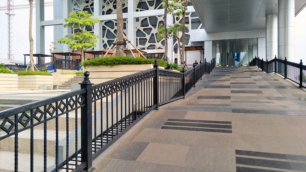 Caption: A photo of an outdoor accessible ramp next to stairs at MNC Studios in Jakarta, Indonesia. (Local Guide Suparno Jumar)