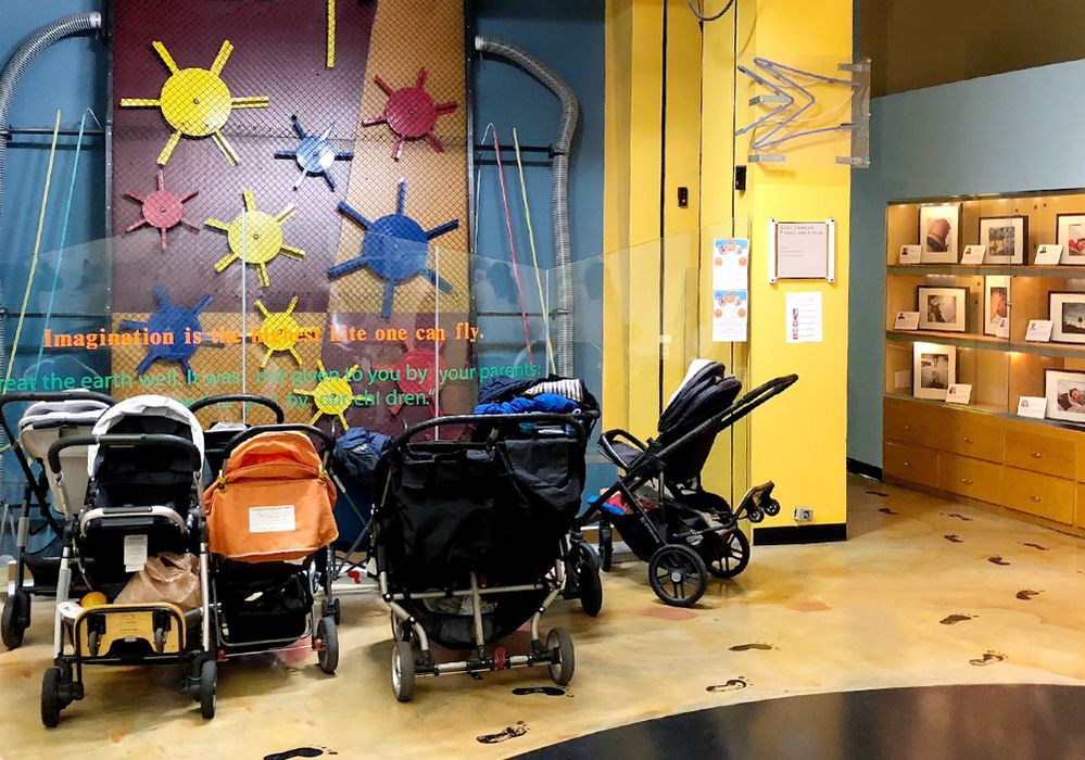 Caption: A photo of a variety of strollers parked inside the Zimmer Children's Museum in Los Angeles, California, USA. (Local Guide Amir Khamesi)