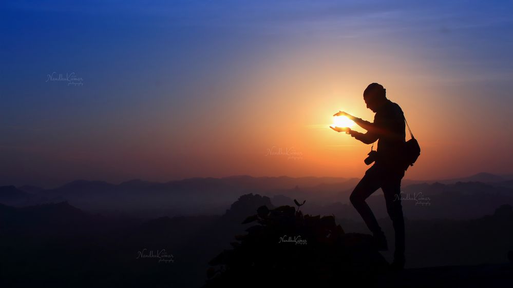 Photographer with Sun in hand at Matanga Hill, Hampi, India