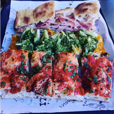 Pizza al Taglio (by the slice) from Gabriele Bonci's "Pizzarium" restaurant in Rome (he's pretty much the Michelangelo of Pizza Romana).  Each day the toppings change depending on what's fresh. Here there's a spicy tomato, broccoli and mortadella