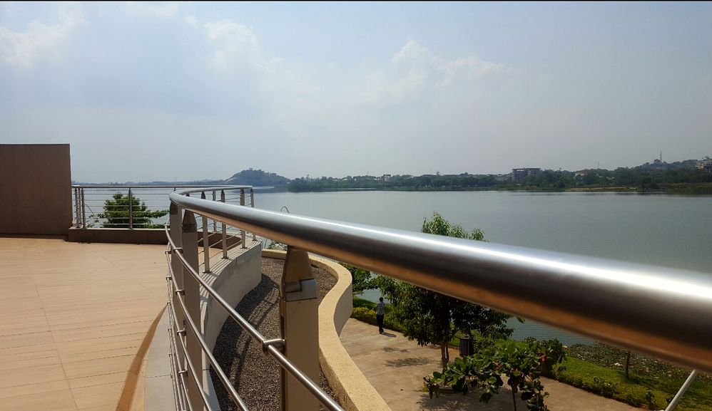 Caption: A photo showing the Jabi Mall Balcony overlooking the Lake and a hill across the lake