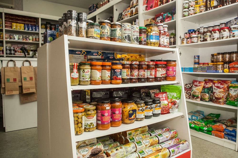 Caption: A photo of a shelving unit at a grocery store filled with jarred goods such as sauces, olives, and more in Poltava, Ukraine. (Local Guide Alexander Vanin)