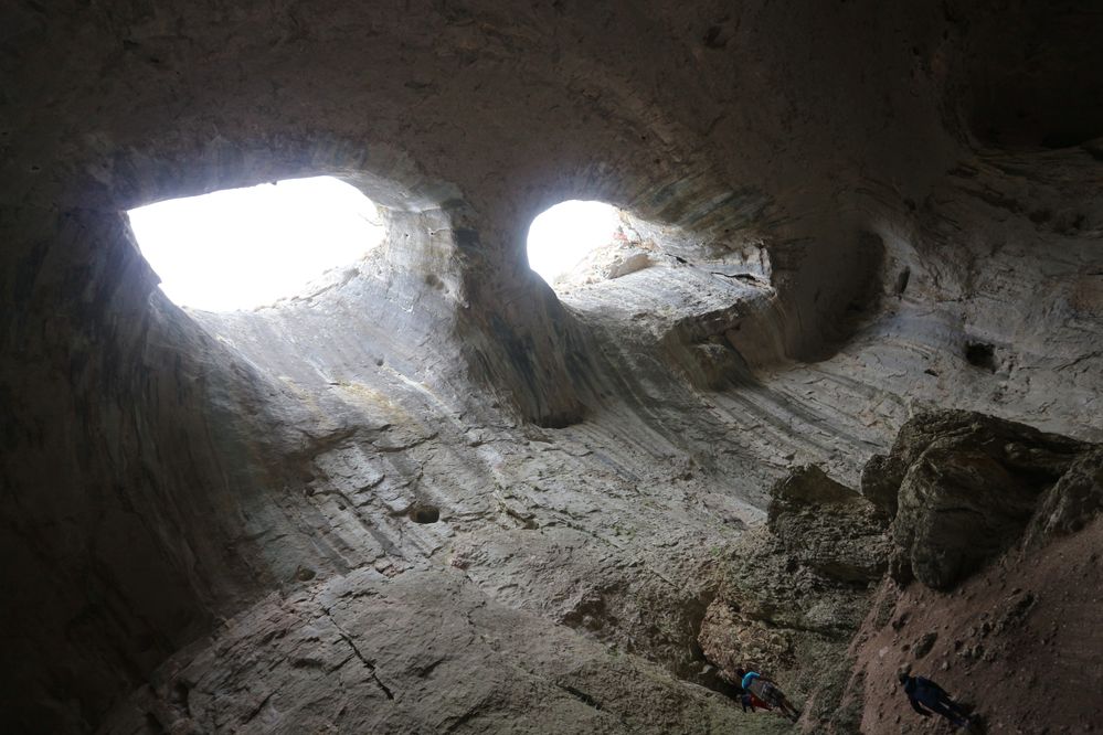 Caption: A photo from below of the roof of Prohodna cave, with two almond-shaped holes resembling eyes. (Local Guide @sonnyNg)