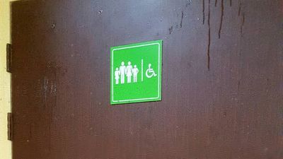 Caption: A restroom door with accessibility sign