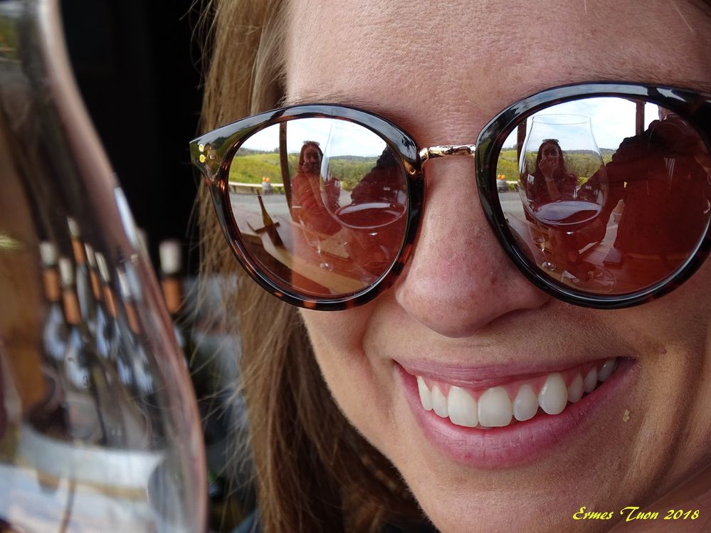 Caption: smiles and reflections, glass on glasses