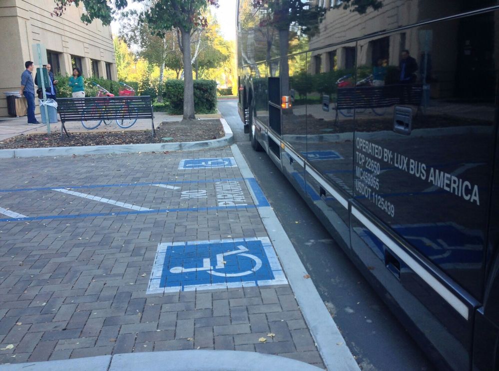 Caption: A dedicated parking lot with accessibility sign at the Quad Campus, Googleplex