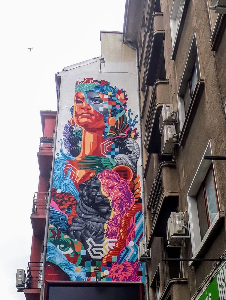 Caption: A photo of very colourful street art drawn on the wall of a building (Local Guide @MoniDi)