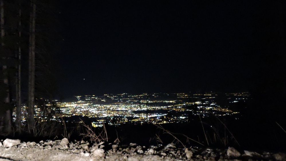 Caption: A photo from Vitoshko lale ski slope over the town of Sofia, Bulgaria during the night hours. The lights of the city are sparkling in the dark.