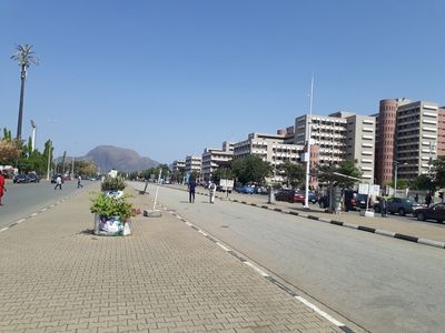 A view of the  landscape on the right-side of the Federal Secretariat Abuja with the Ministry of Youth and Sport Building to the right and Aso Rock in the background straight ahead