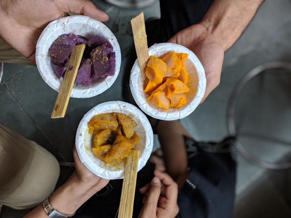 Caption: A photo of three bowls in three people’s hands each filled with a different kind of ice cream from Kuremal Mohanlal Kulfiwale in Delhi, India. (Local Guide Himanshu Rao)