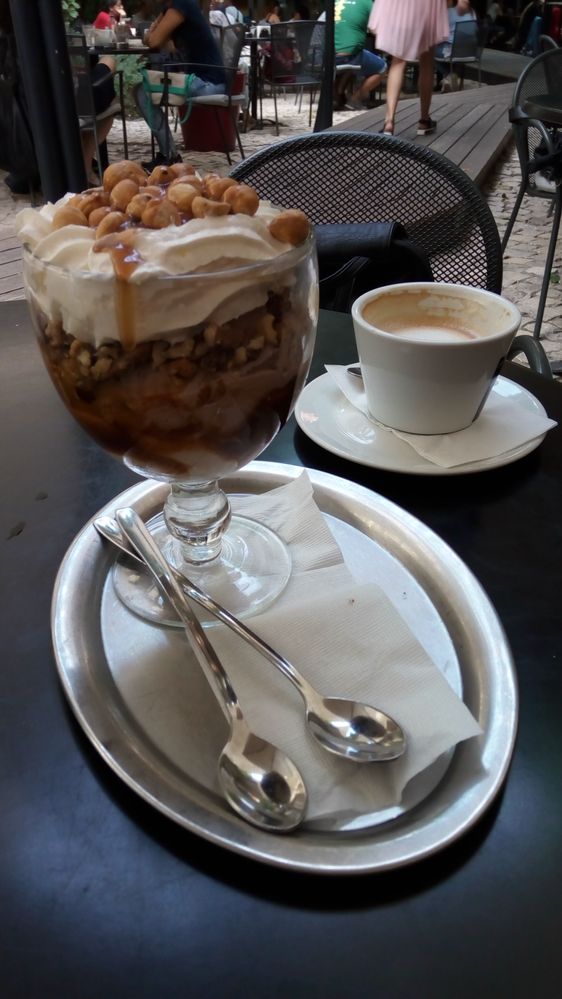 Caption: A photo of chocolate hazelnut sundae on a plate, two spoons and a cup of coffee (Local Guide kukufina)