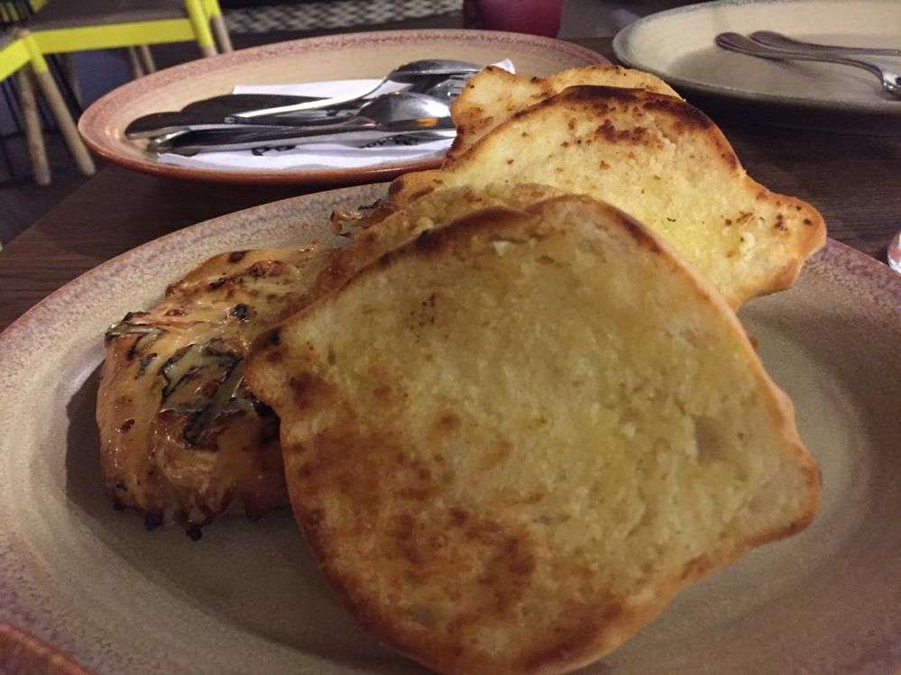 A Photo of 1/2 chicken with garlic bread
