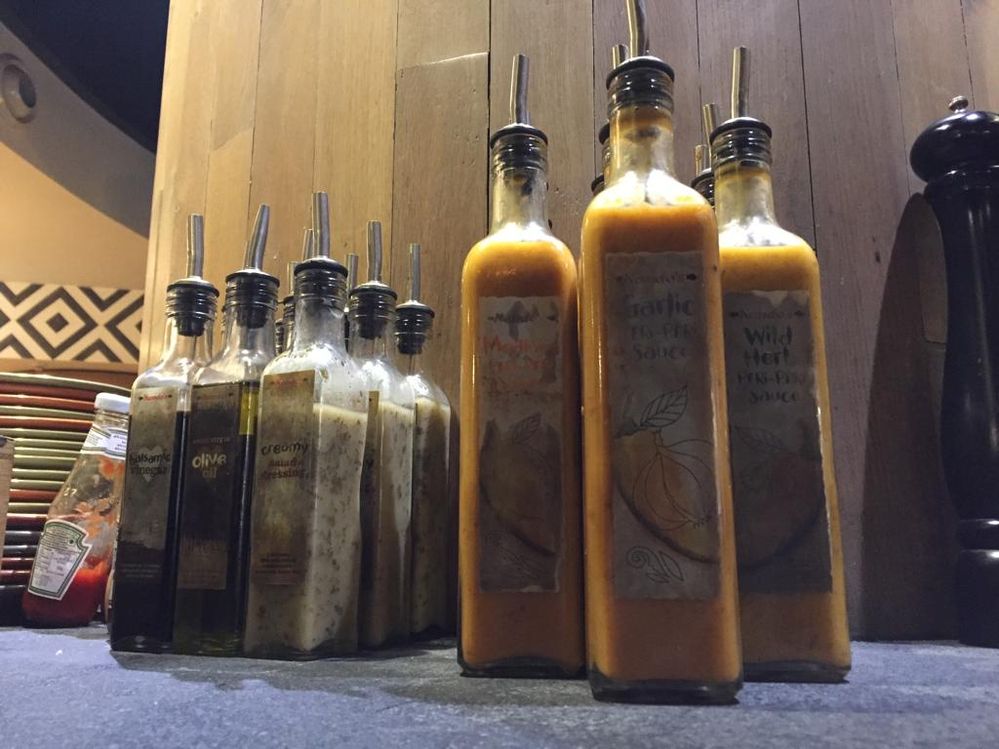 A photo of varieties of their special  peri peri and garlic sauce : Spicy !