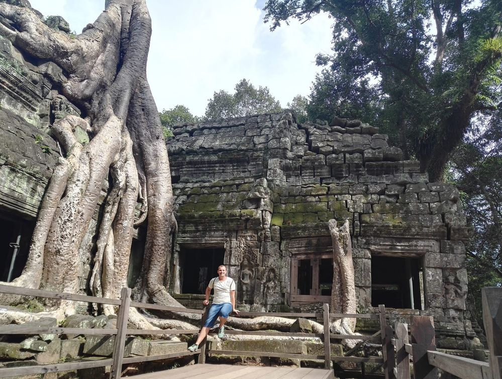 Caption: A photo taken while visiting Angkor Wat temple, I was posing for a photo in front of the beautiful ruins of the temple. (Local Guide @TsekoV)
