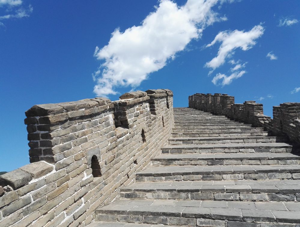 Caption: A photo of the Great Wall which resembles as if a staircase to heaven, white clouds and blue sky. (Local Guide @TsekoV)